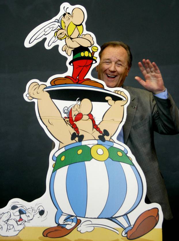 FILE PHOTO: Asterix artist and author Uderzo poses next to a model of Asterix and Obelix at the Frankfurt book fair