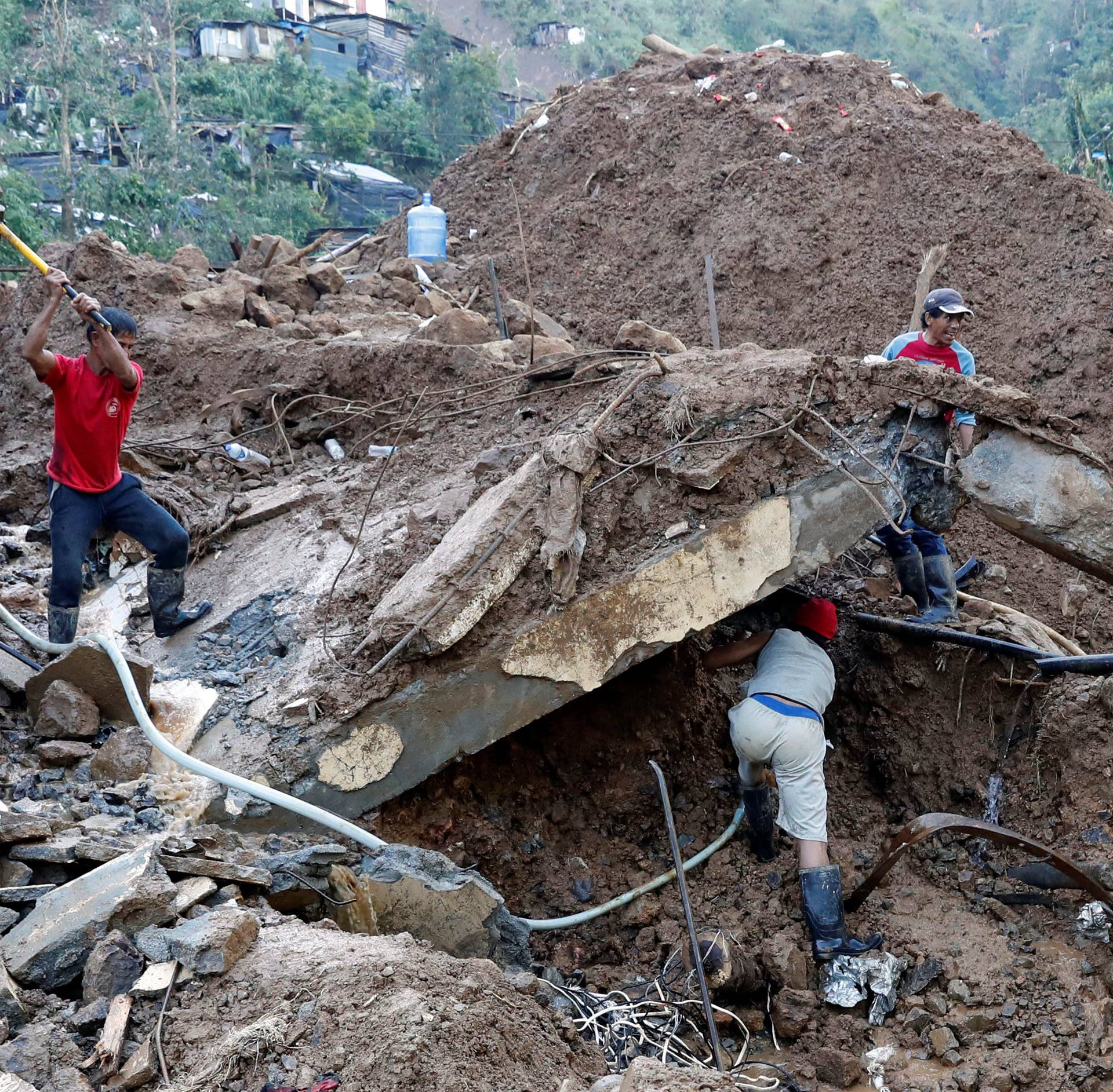 Rescuers continue their search for missing miners in a landslide caused by Typhoon Mangkhut at a small-scale mining camp in Itogon