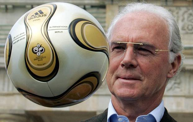 FILE PHOTO: Franz Beckenbauer, President of Germany's World Cup organising committee, plays with a golden soccer