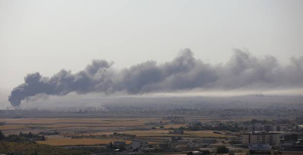 Smoke is seen over the Syrian town of Ras al-Ain as seen from the Turkish border town of Ceylanpinar