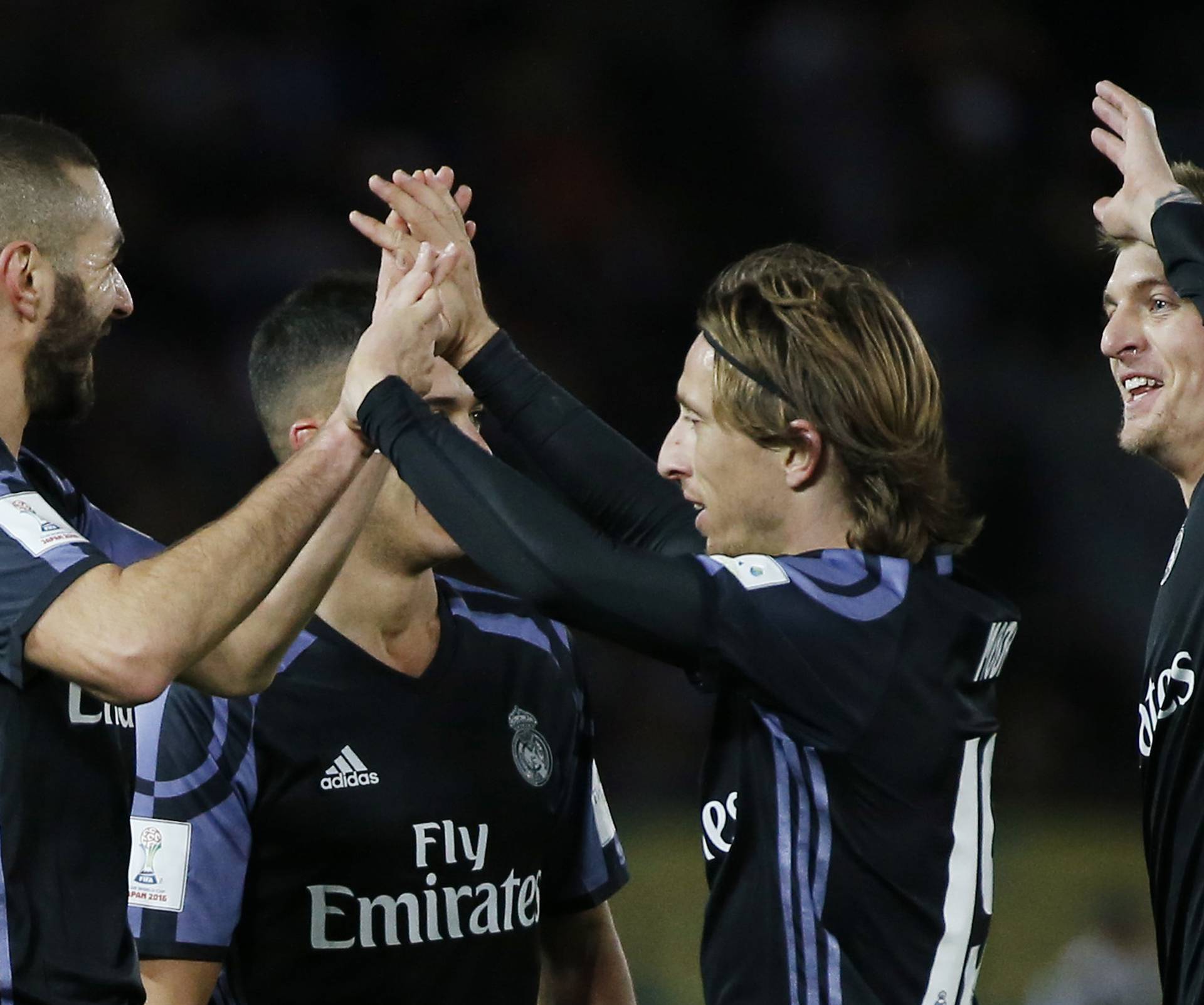 Real Madrid's Karim Benzema celebrates scoring their first goal with Luka Modric and teammates