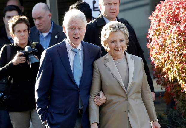 Democratic U.S. presidential nominee Hillary Clinton and her husband former U.S. president Bill Clinton depart after voting in the U.S. presidential election at the Grafflin Elementary School in Chappaqua