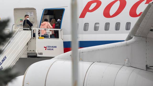 Russian diplomats board a plane in Prague international airport