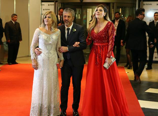 Argentine soccer player Lionel Messi's parents Jorge and Celia and his sister Maria Sol pose at his wedding to Antonela Roccuzzo in Rosario