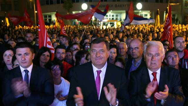 Dodik celebrates the results of a referendum over a disputed national holiday during an election rally in Pale