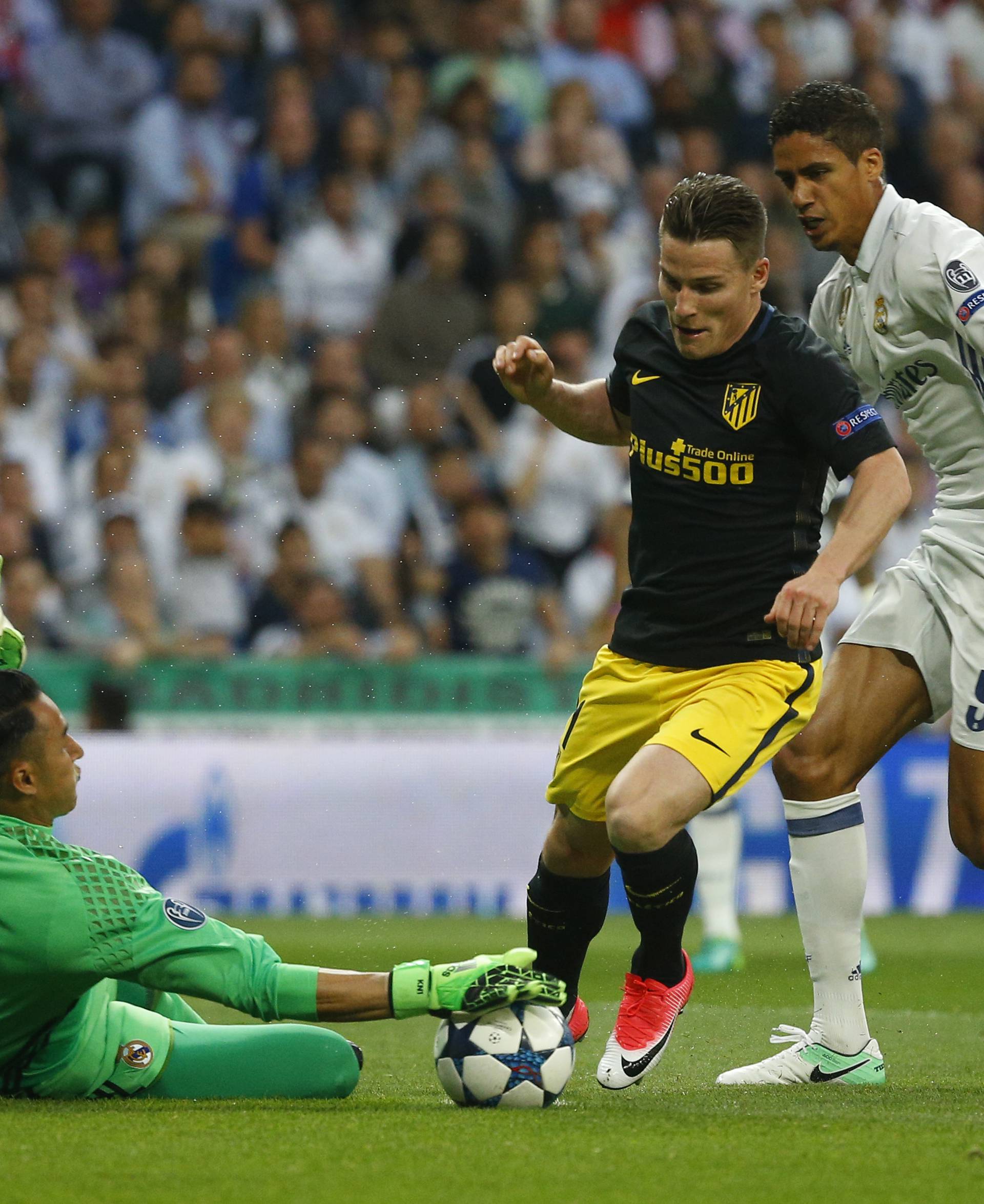 Atletico Madrid's Kevin Gameiro in action with Real Madrid's Raphael Varane and Keylor Navas