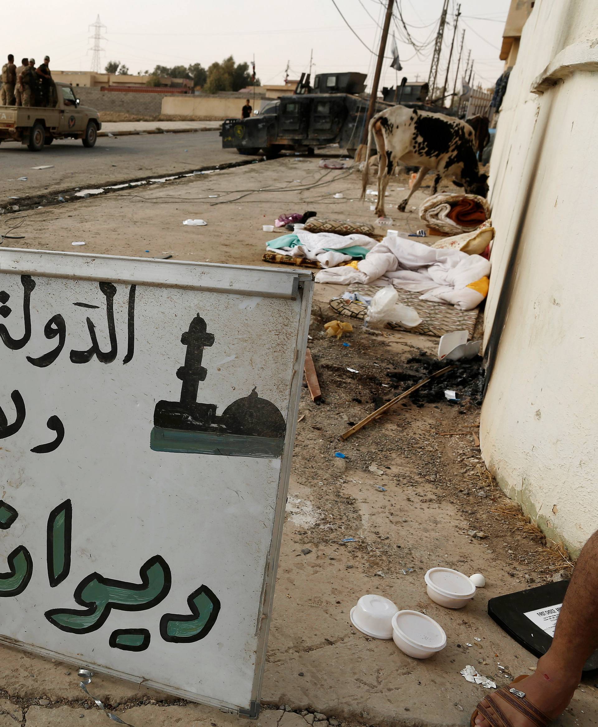 A sign which reads "Islamic State, Nineveh Governorate, Council of Mosques" is seen along a street of the town of al-Shura