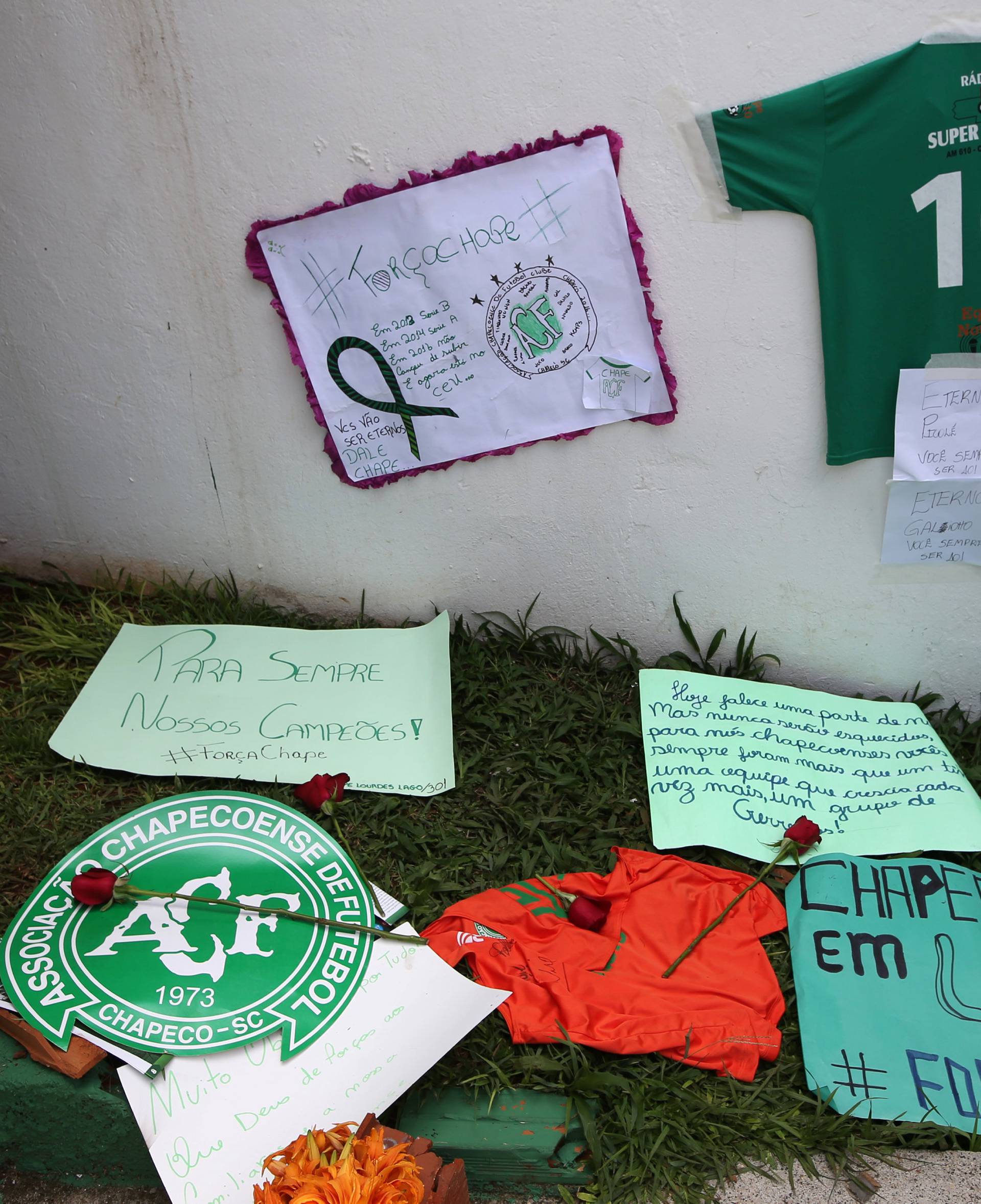 Flowers and messages are seen next to a Chapecoense soccer team flag in tribute to their players in front of the Arena Conda stadium in Chapeco