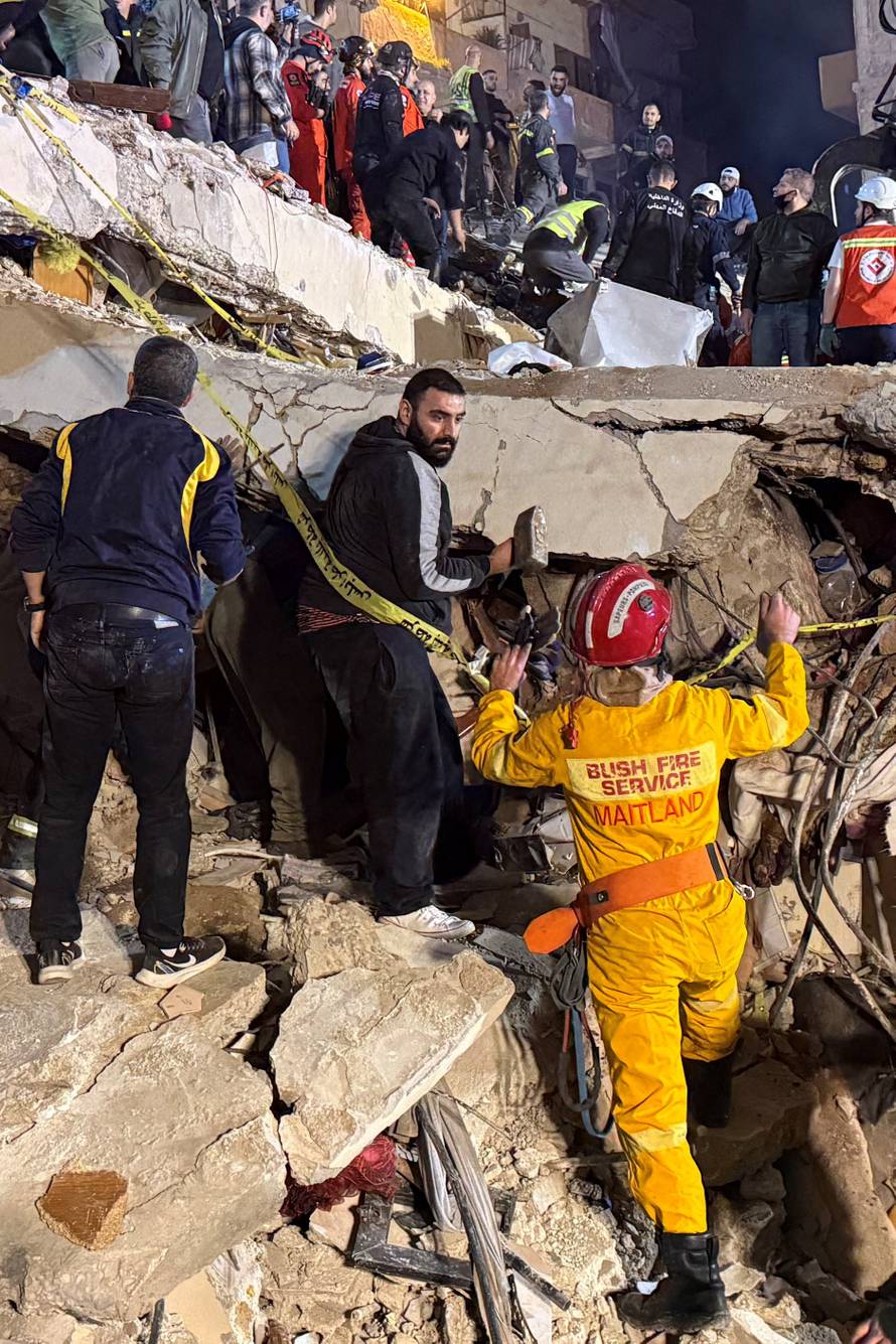 Rescue teams search for survivors after a building collapsed in Tripoli
