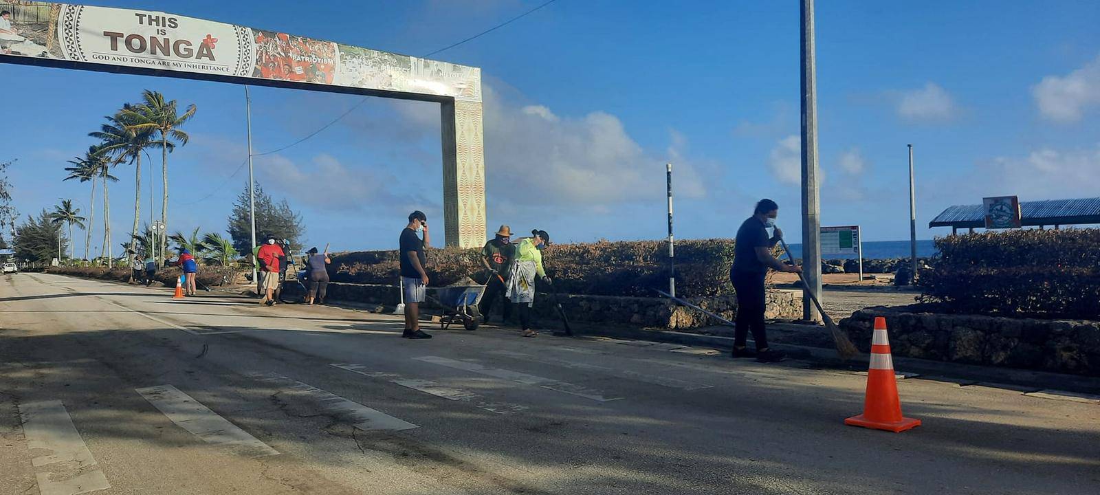 People clean debris following volcanic eruption and tsunami, in Nuku'alofa