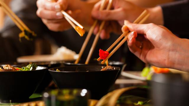 Young people eating in Thai restaurant