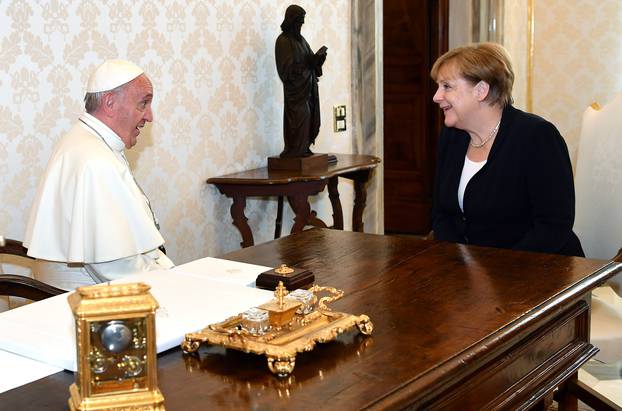 German Chancellor Angela Merkel talks with Pope Francis during a meeting at the Vatican