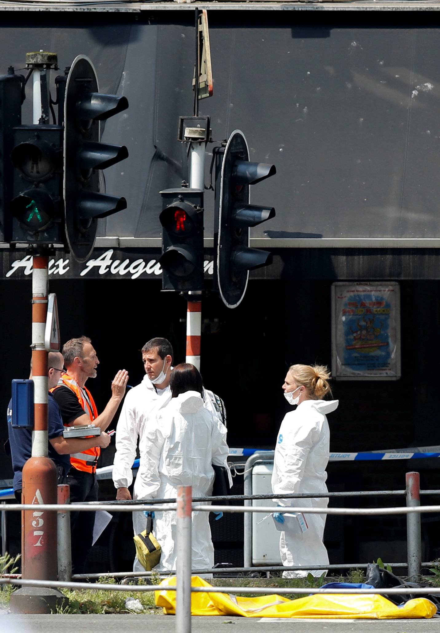 Forensics experts are seen on the scene of a shooting in Liege