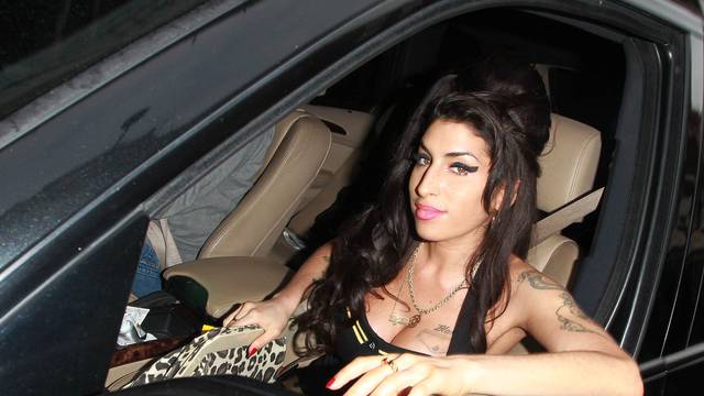 Amy Winehouse looks reasonably put together as she is spotted sitting in the front seat of a vehicle in Covent Garden