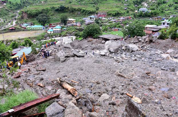 Rescue workers search for survivors after a landslide caused by heavy rains at Rulehar village