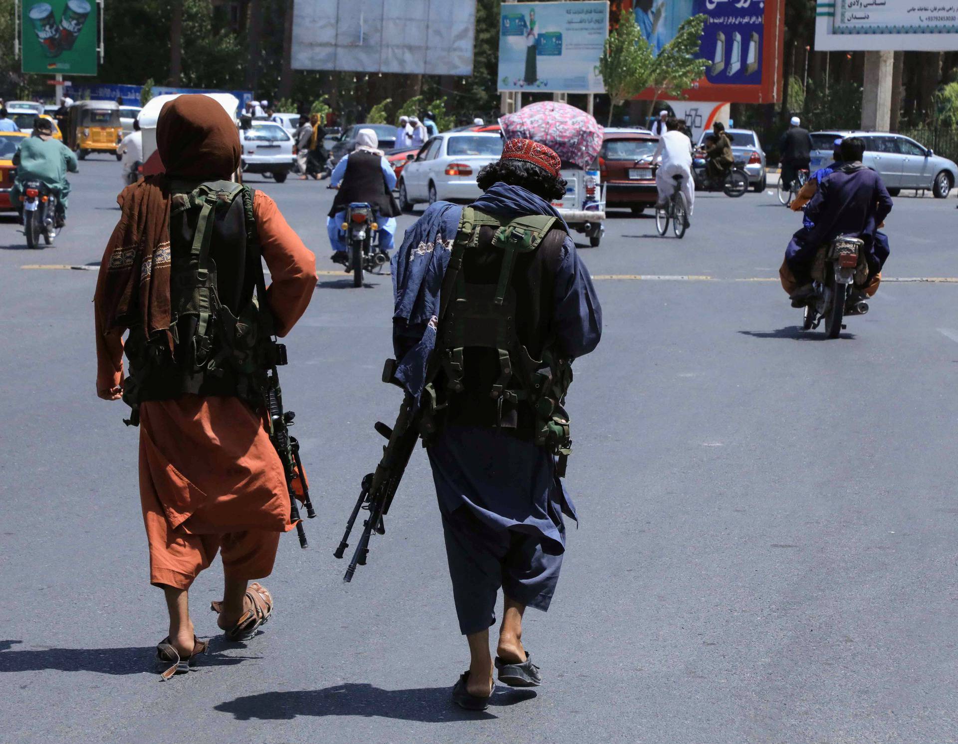 Taliban forces patrol a street in Herat