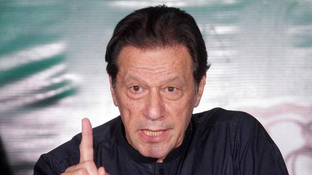 FILE PHOTO: Pakistan's former Prime Minister Imran Khan gestures as he speaks to the members of the media at his residence in Lahore