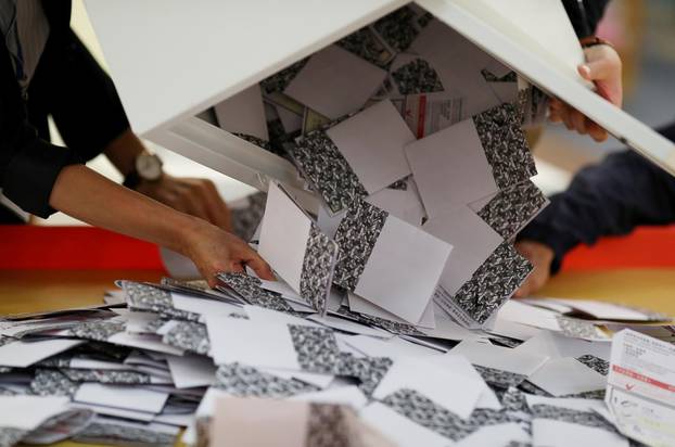 Officials open a ballot box at a polling station in Kowloon Tong, Hong Kong