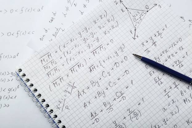 Notebook with different mathematical formulas and pen, top view