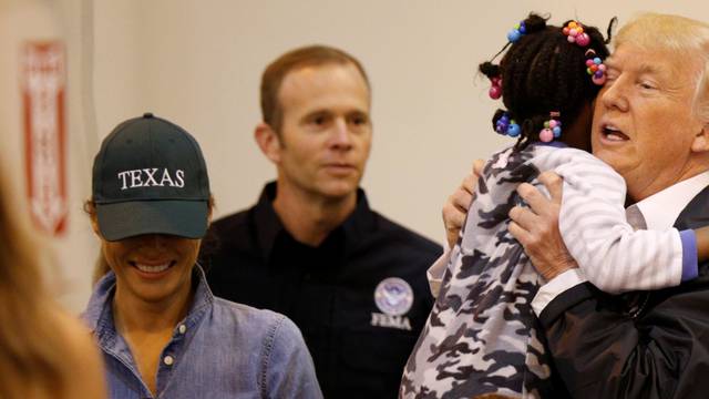 U.S. President Donald Trump and first lady Melania Trump greet children at the NRG Center where they met with flood survivors of Hurricane Harvey, in Houston