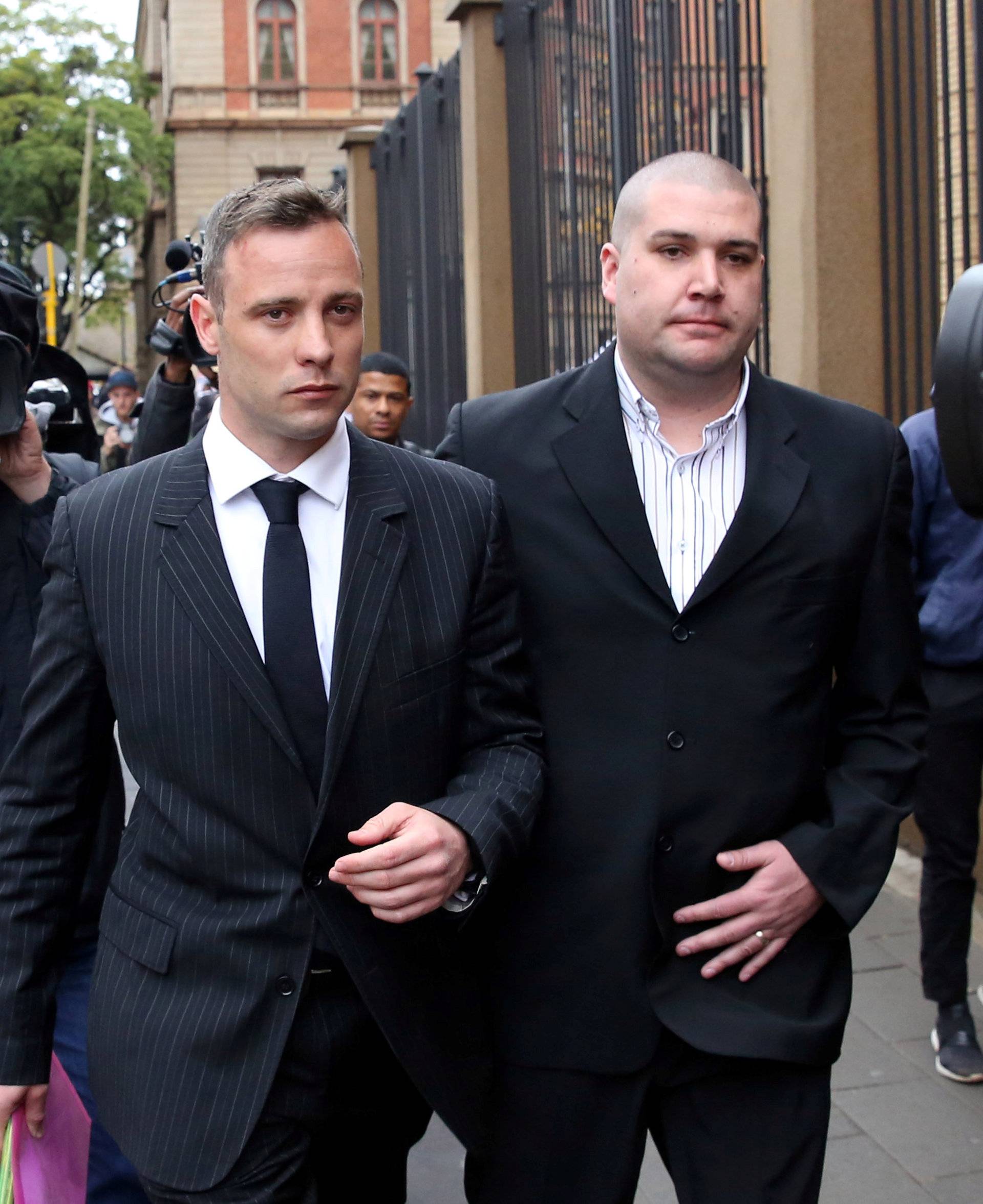 Former Paralympian Oscar Pistorius leaves during a court break at the Pretoria High Court