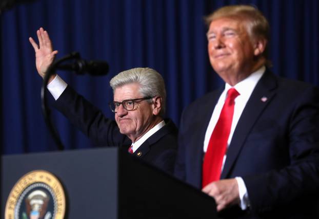 U.S. President Donald Trump stands next to Mississippi Governor Phil Bryant during a campaign rally in Tupelo