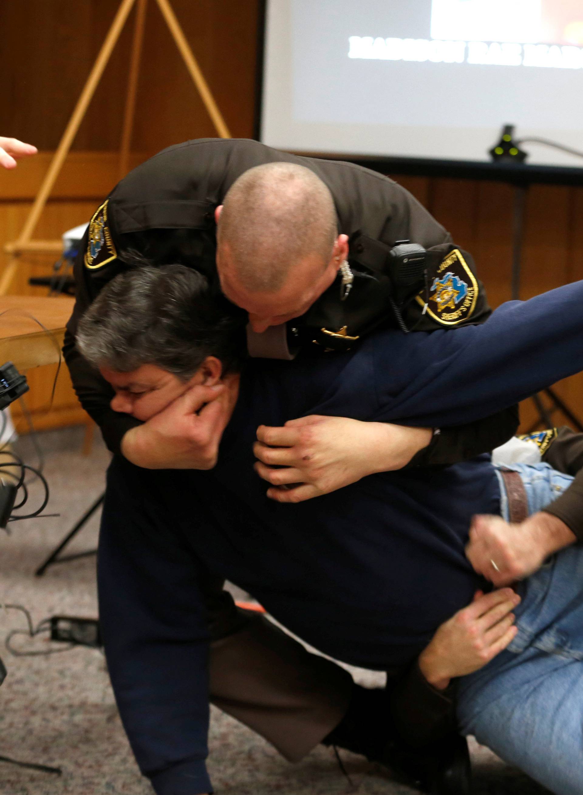 Eaton County Sheriffs restrain Randall Margraves after he lunged at Larry Nassar, during victim statements of his sentencing in the Eaton County Circuit Court in Charlotte