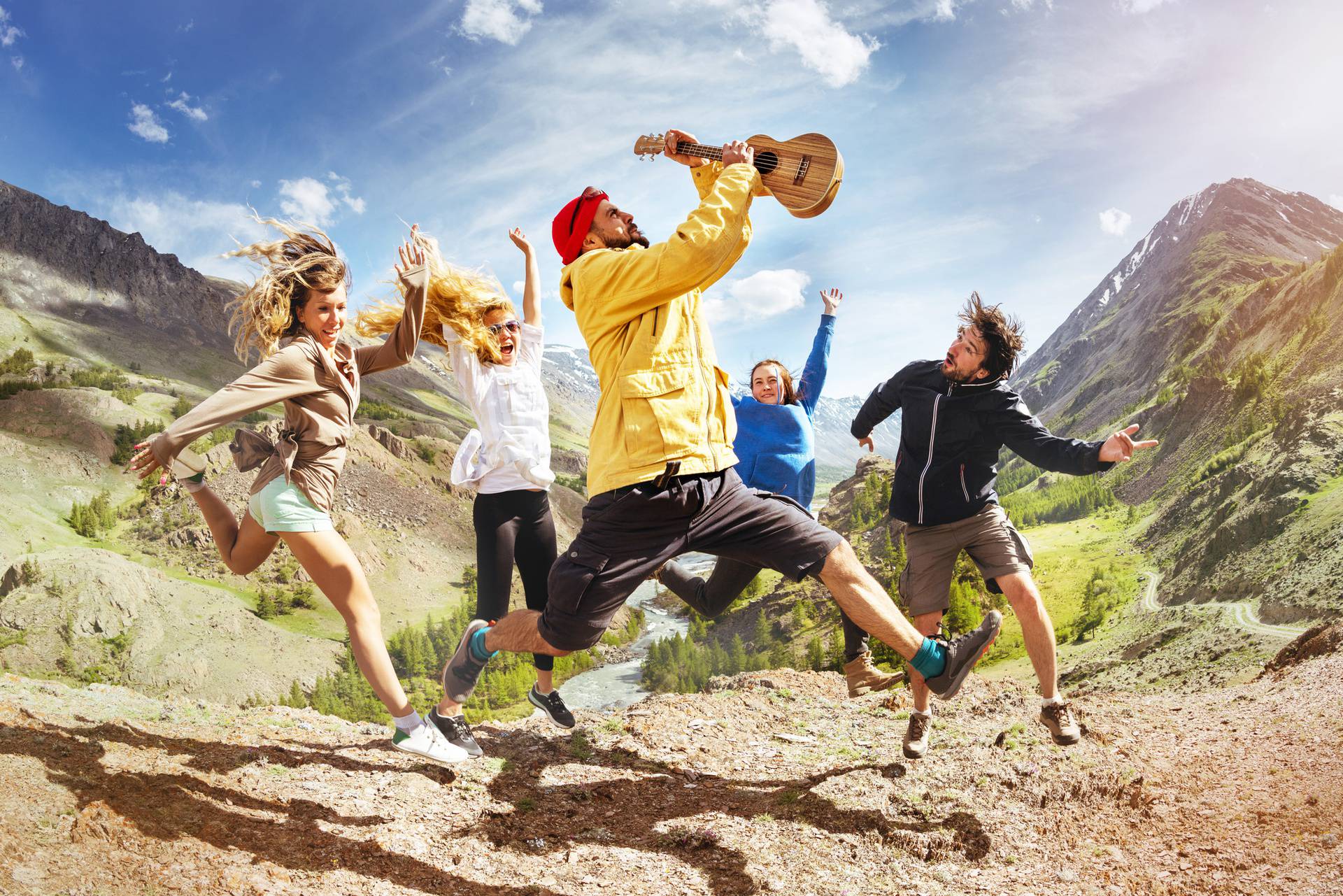 Group of happy friends music jumps trekking fun