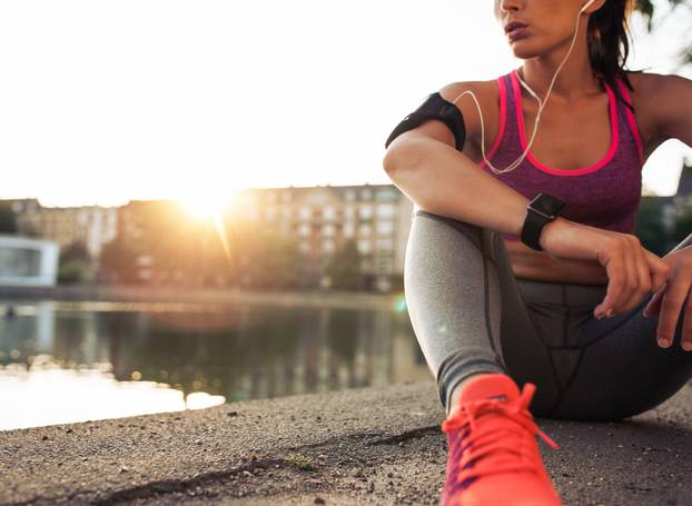 Young,Woman,Runner,Resting,After,Workout,Session,On,Sunny,Morning.