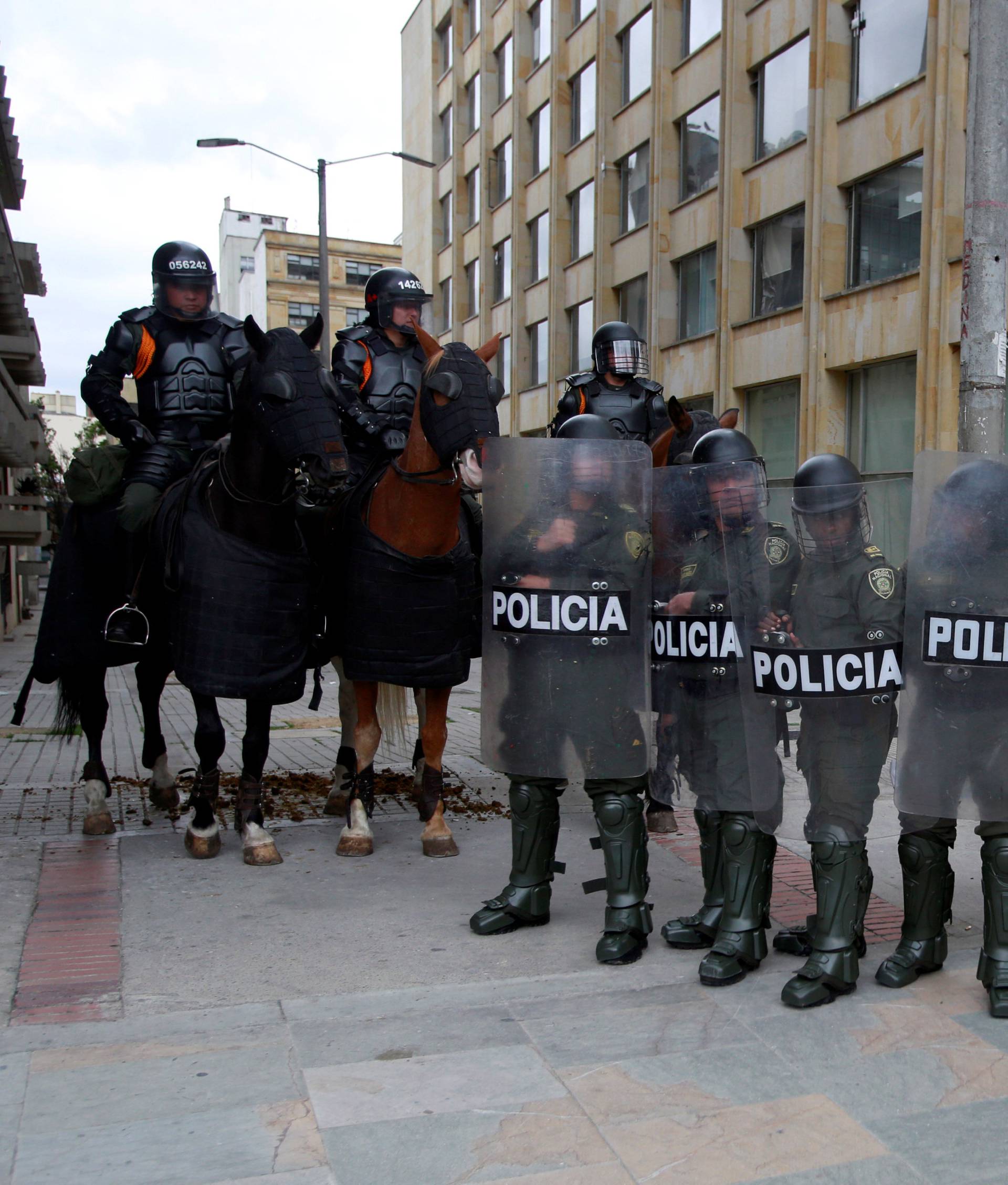 Riot policemen stand during May Day protests in Bogota, Colombia