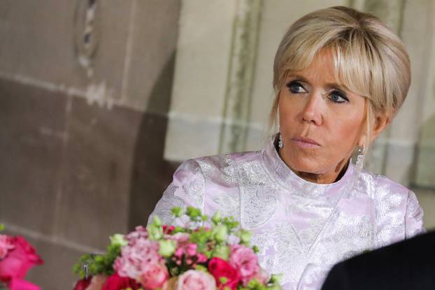 French President's wife Brigitte Macron listens to speeches at the start of an official state dinner with with Japan's Crown Prince Naruhito at the Chateau de Versailles castle