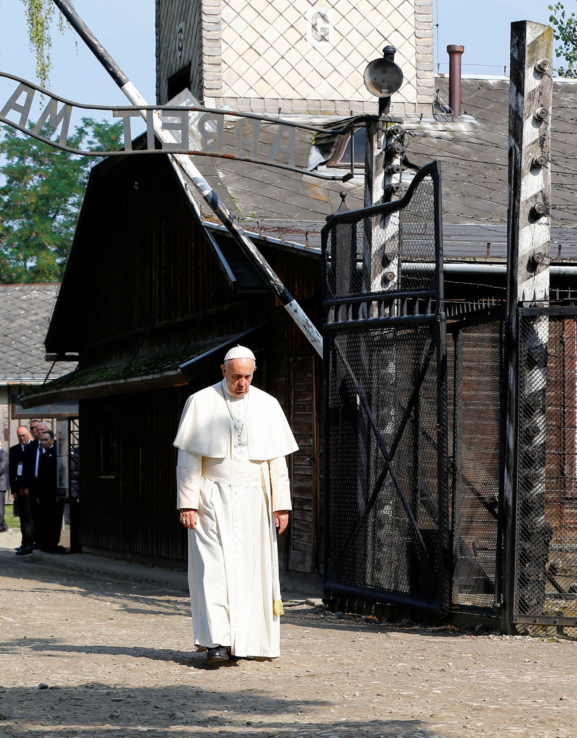 Pope Francis walks through Auschwitz's notorious gate during his visit to the former Nazi death camp