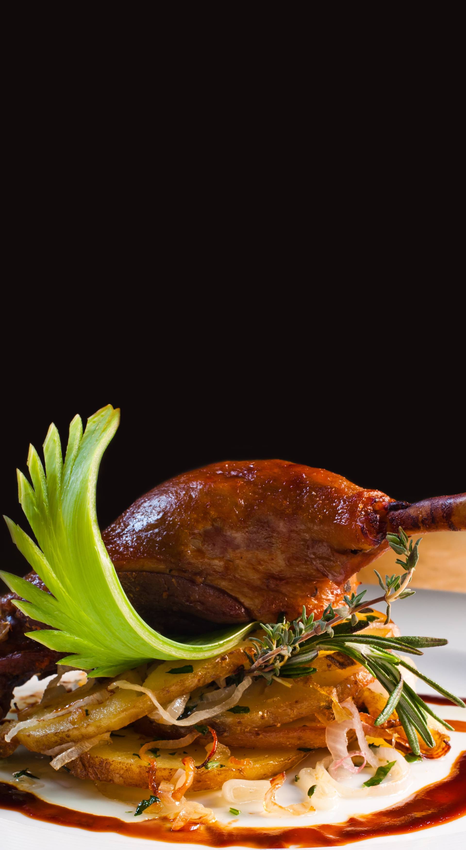 Appetizing duck confit with potato and onions. Baked delicatessen pestle