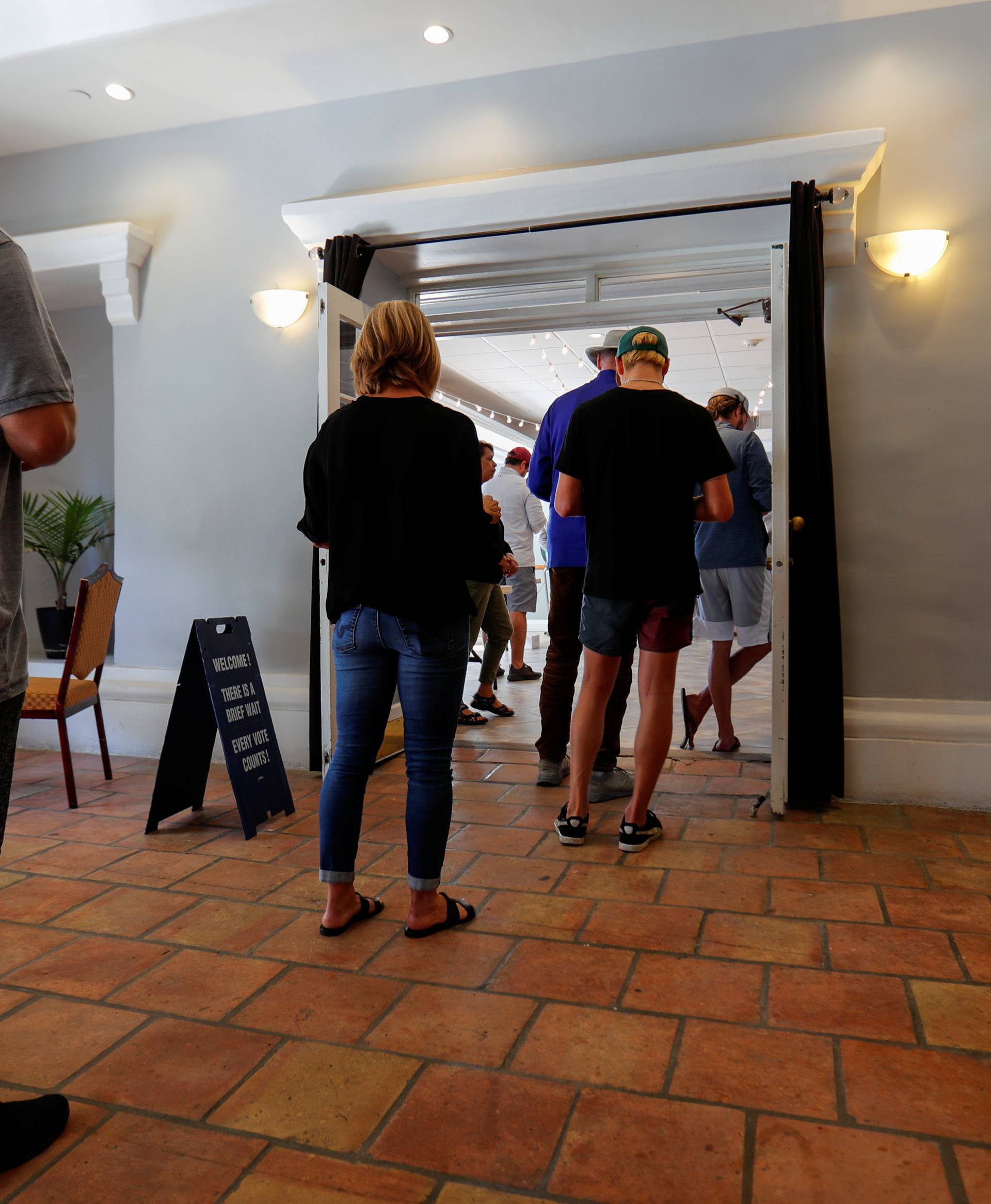 Voters wait in line to cast their ballot during midterm elections in Newport Beach, California