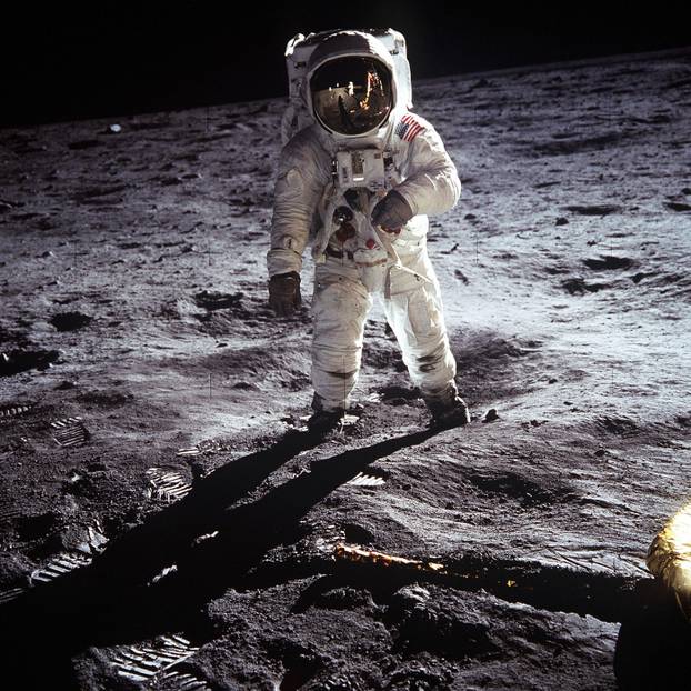 : Astronaut Buzz Aldrin, Lunar Module pilot, walks on the surface of the Moon near the leg of the Lunar Module (LM) "Eagle" during the Apollo 11 extravehicular activity (EVA). Astronaut Neil A. Armstrong, commander, took this photograph with a 70mm lunar 