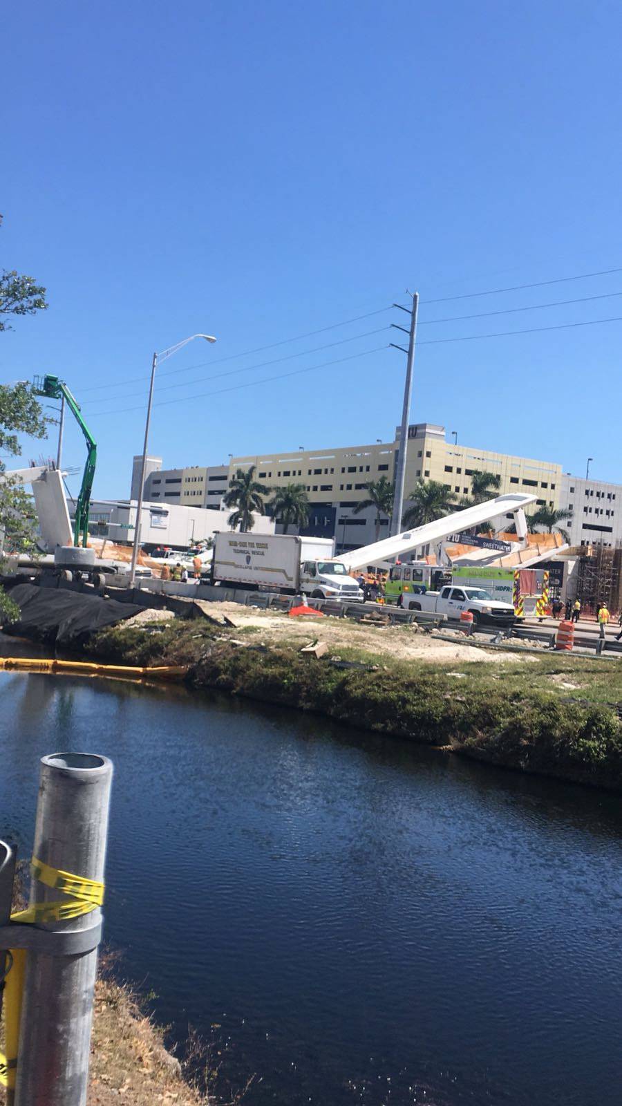 Emergency crews work at the scene of a collapsed pedestrian bridge at Florida International University in Miami