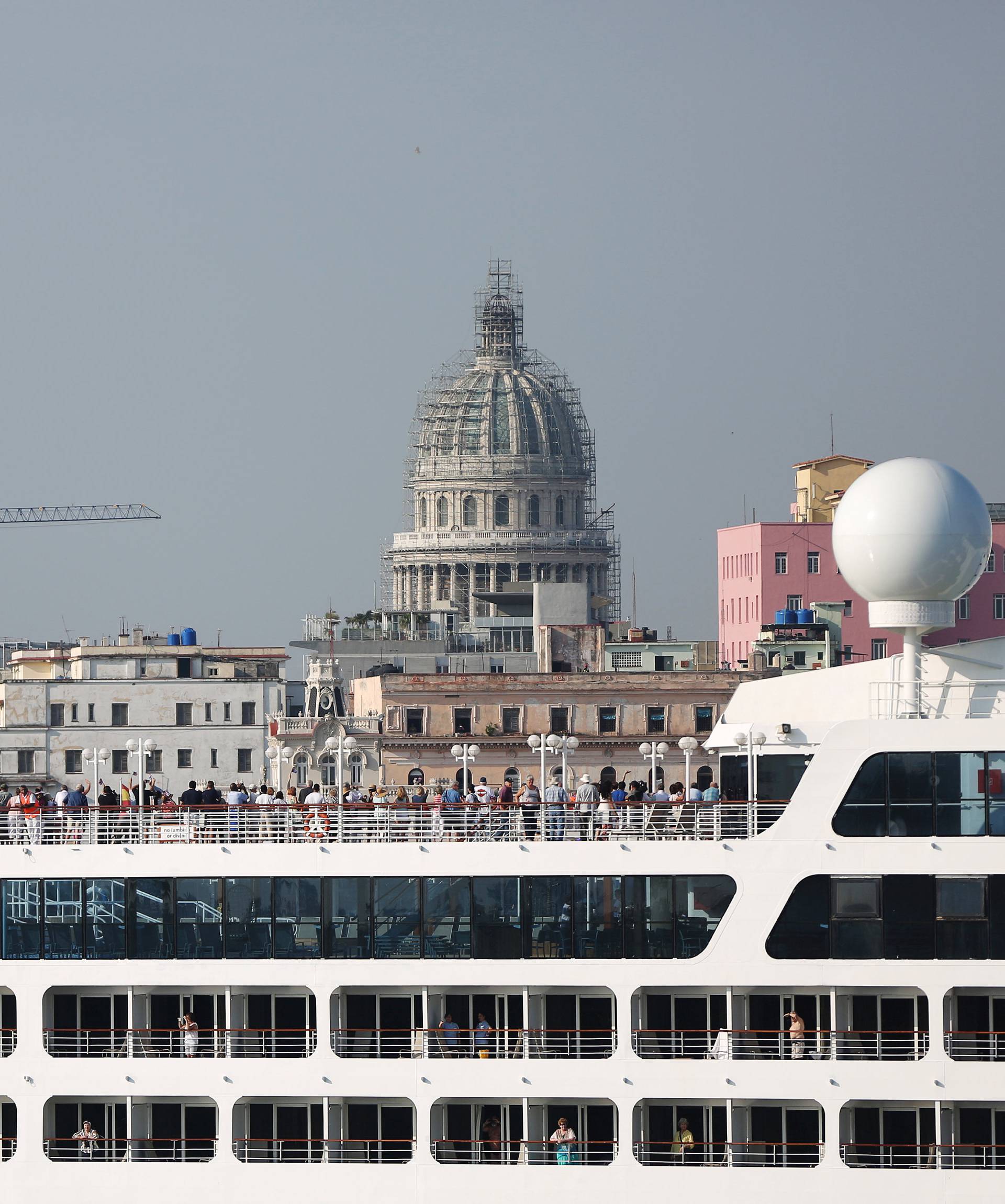 People look at the city of Havana from the deck of U.S. Carnival cruise ship Adonia as it enters at the Havana bay, the first cruise liner to sail between the United States and Cuba since Cuba's 1959 revolution, Cuba