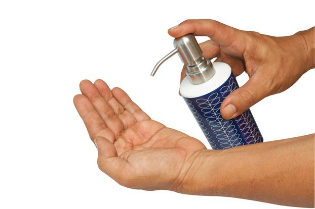finger pushing soap dispenser