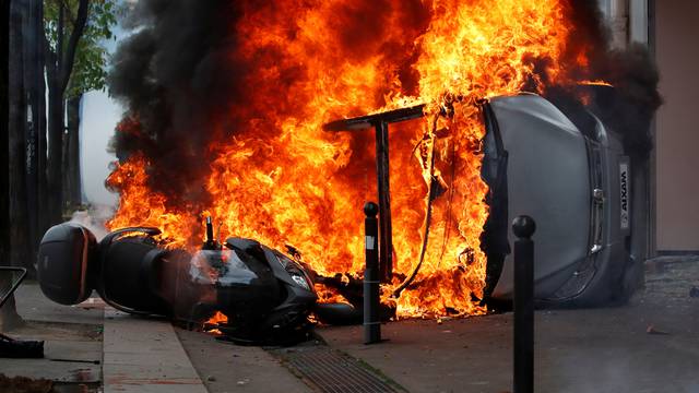 A car burns outside a Renault automobile garage during clashes at the May Day labour union march in Paris