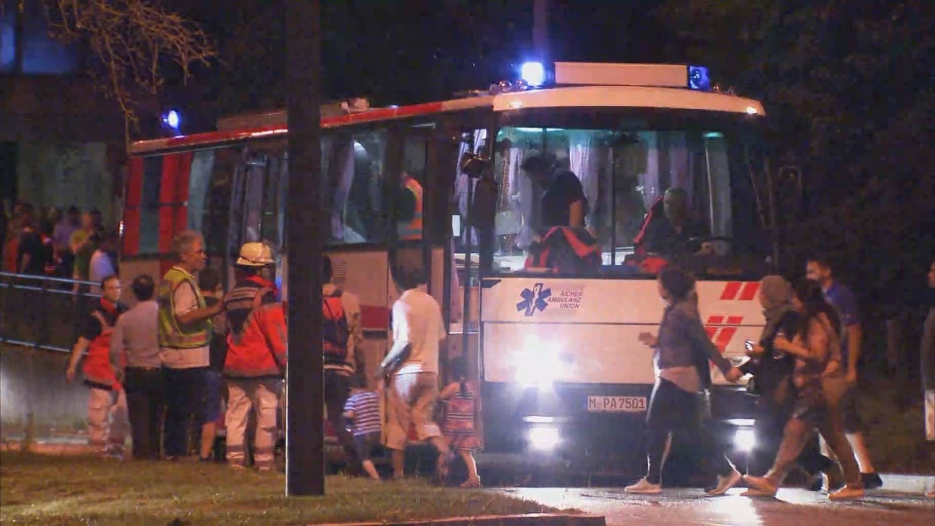 Screen grab shows people being evacuated onto bus following shooting rampage at shopping mall in Munich