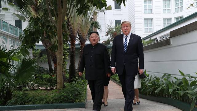 U.S. President Donald Trump and North Korea's leader Kim Jong Un walk in the garden at the Metropole hotel during the second North Korea-U.S. summit in Hanoi