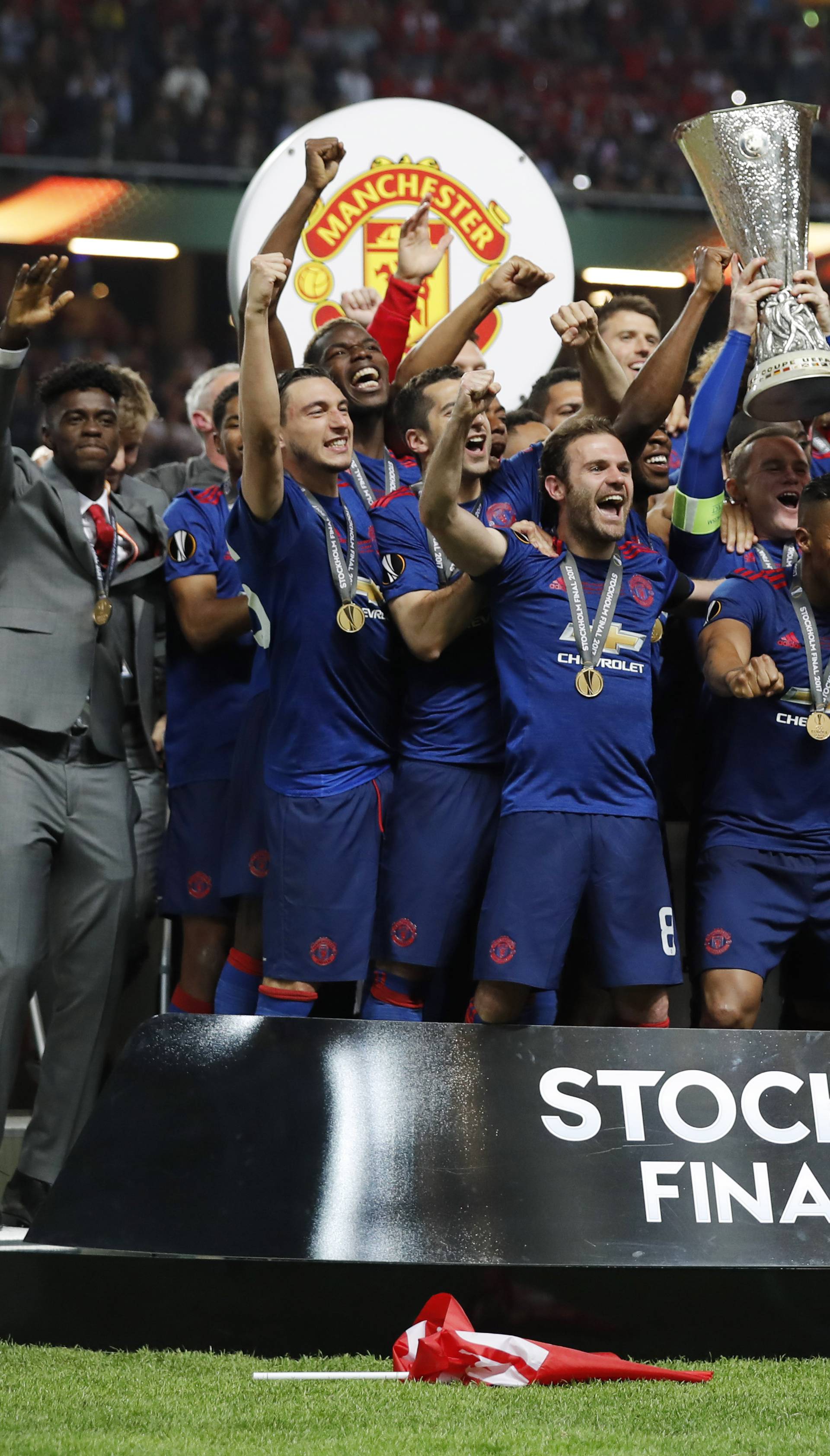 Manchester United celebrate winning the Europa League with the trophy