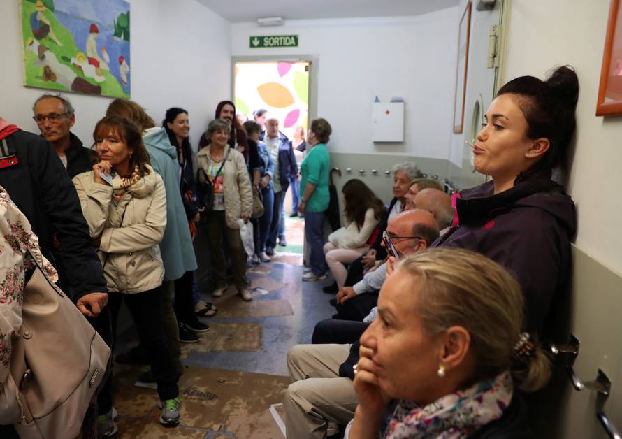 People queue to vote in the banned independence referendum at a polling station in Barcelona