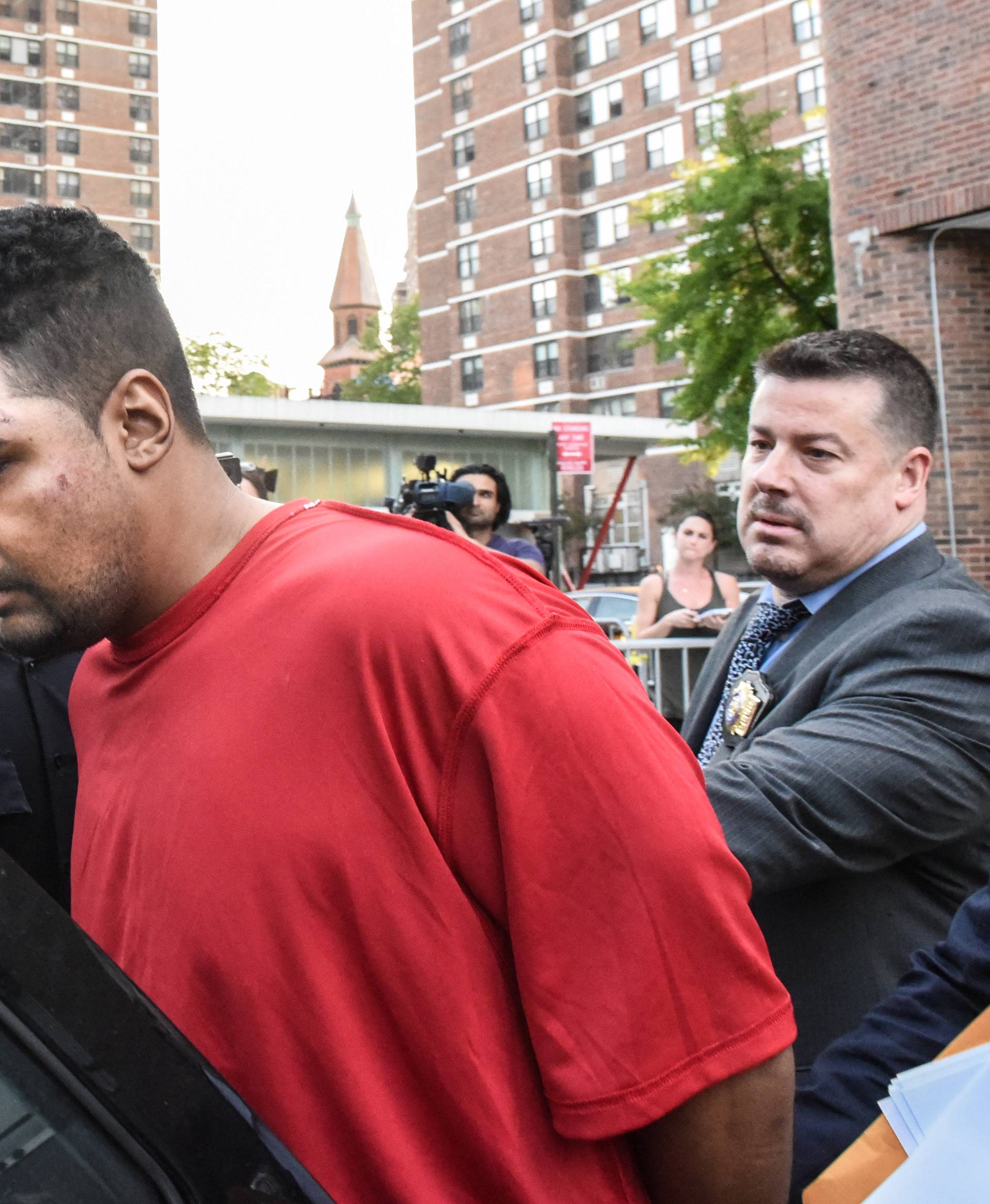 Richard Rojas is escorted after being processed in connection with the speeding vehicle that struck pedestrians on a sidewalk in Times Square in New York City