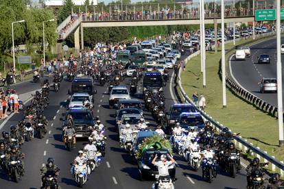 The hearse carrying the casket of soccer legend Diego Maradona drives to the cemetery, in Buenos Aires