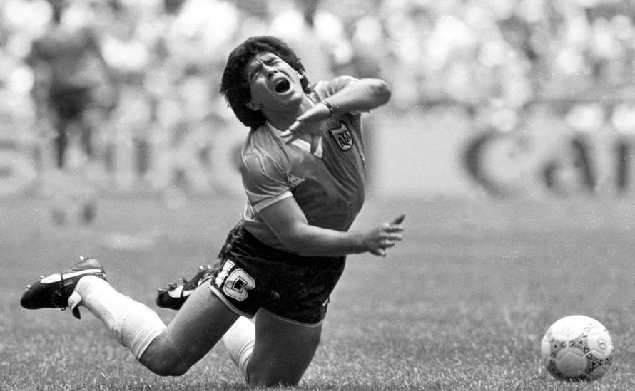 FILE PHOTO: ARGENTINE DIEGO MARADONA FALLS TO THE PITCH IN WORLD CUP MATCH.