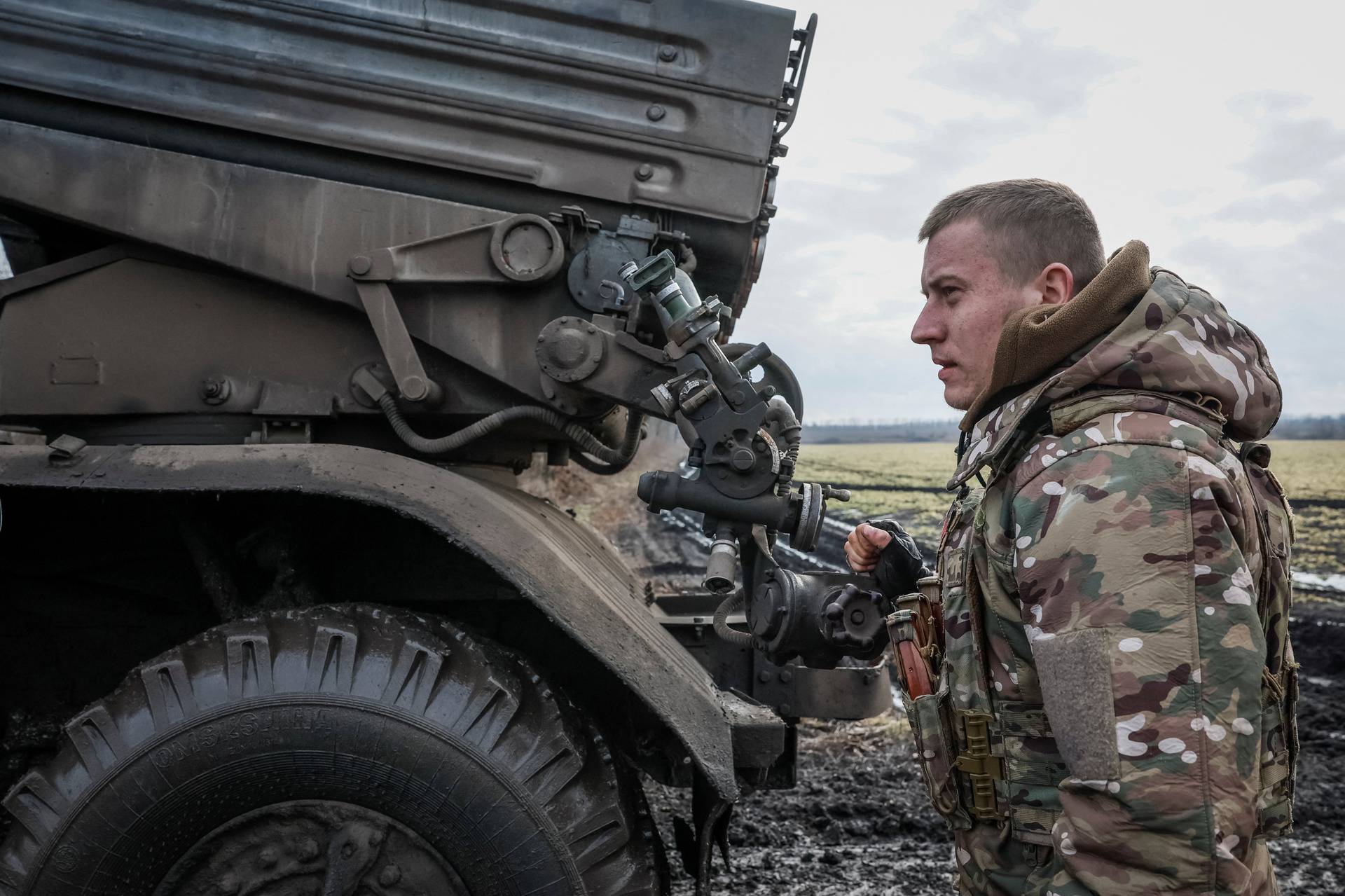 Ukrainian serviceman prepares to fire a BM-21 Grad multiple launch rocket system towards Russian troops in Donetsk region