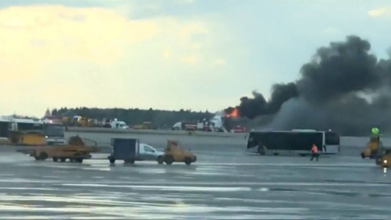 Smoke billows from a Sukhoi passenger plane after it made an emergency landing due to an onboard fire at Sheremetyevo International Airport