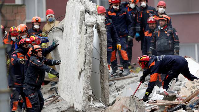 Rescue workers are seen at the site of a collapsed residential building in the Kartal district, Istanbul