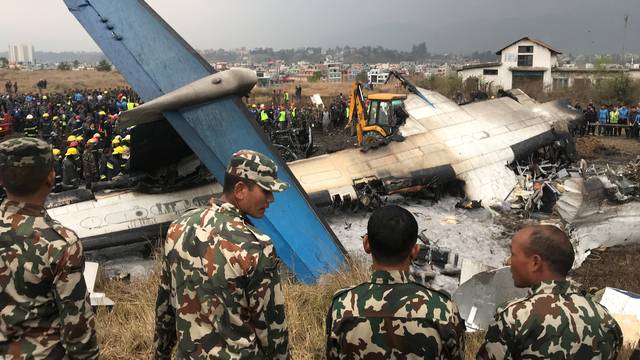 Wreckage of an airplane is pictured as rescue workers operate at Kathmandu airport
